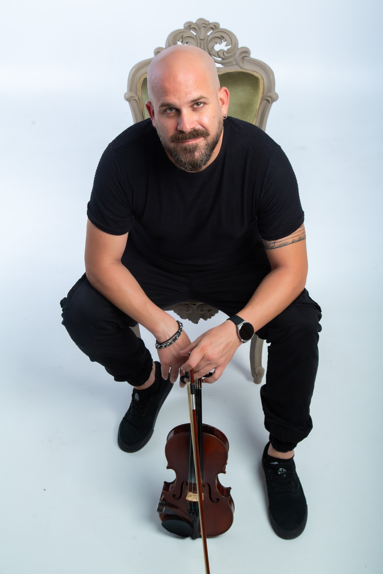 Seated with violin and bow on white background