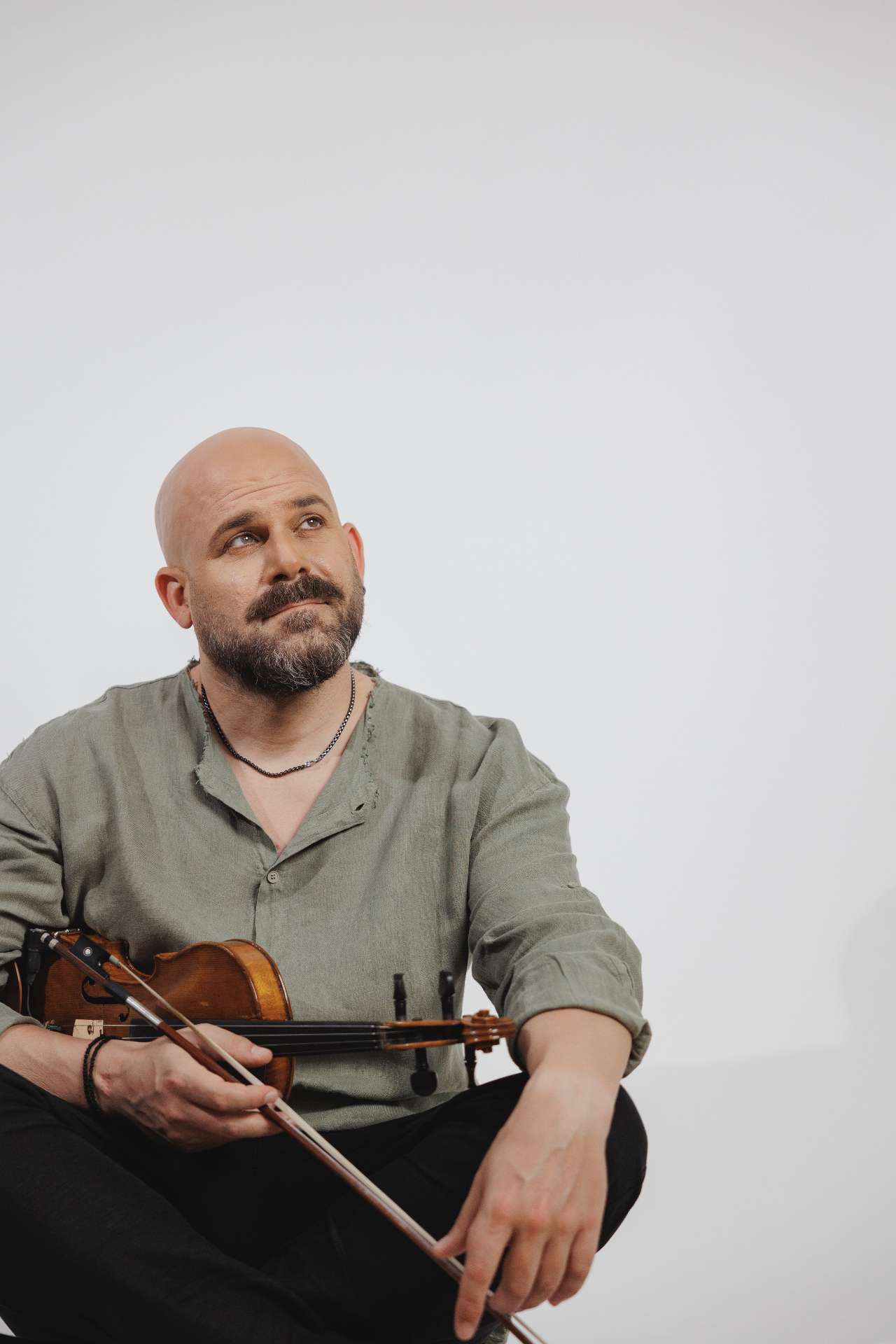 Seated portrait with violin and bow