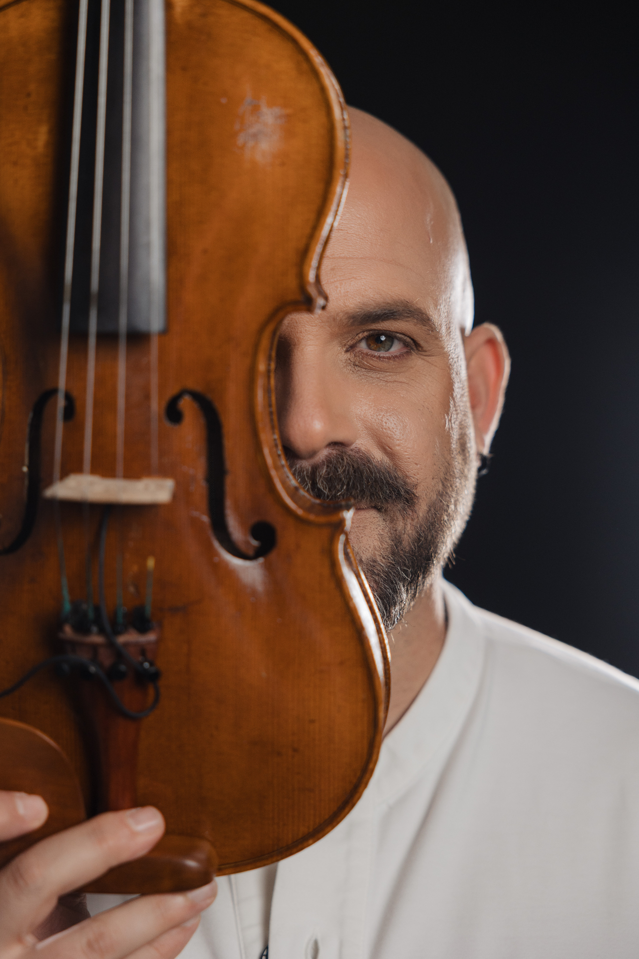 Portrait with violin in front of face